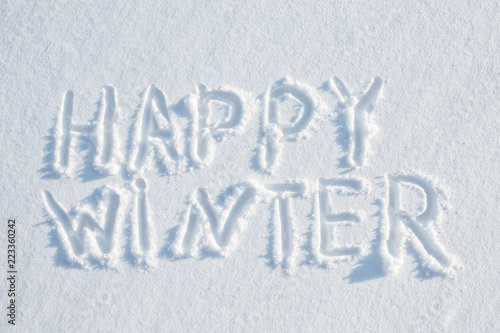 happy winter written on snow