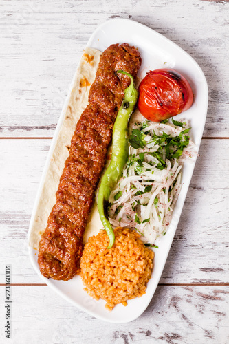 Bild auf Leinwand Adana Kebab Served with Green Vegetables in  White Plate
