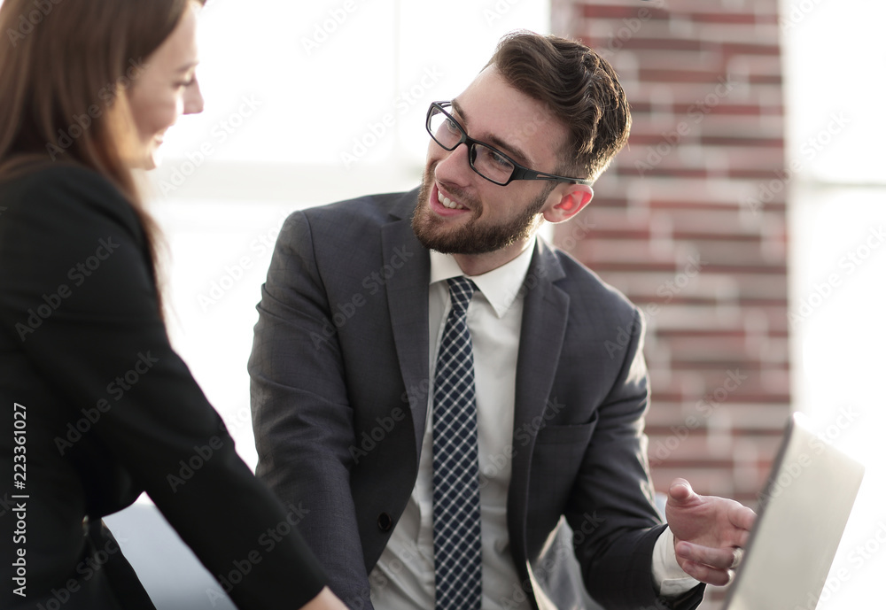 two coworkers discussing fun project over a laptop two coworkers discussing fun project over a laptop