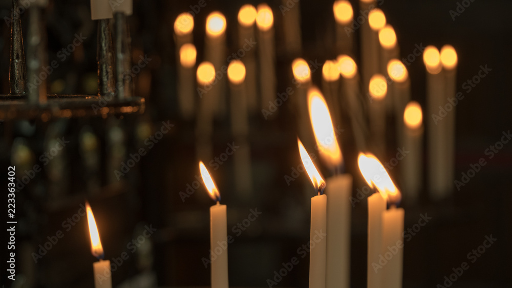background of a candle burning in a church. background of a candle burning in a church.