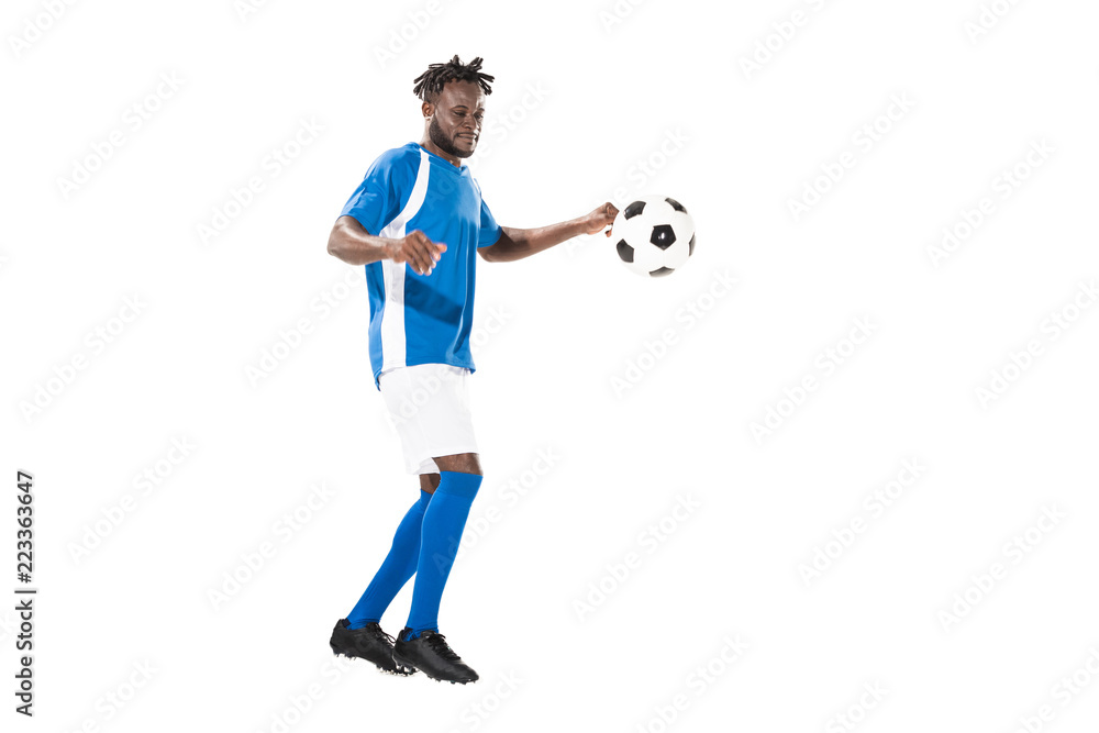 full length view of athletic african american sportsman playing with soccer ball isolated on white