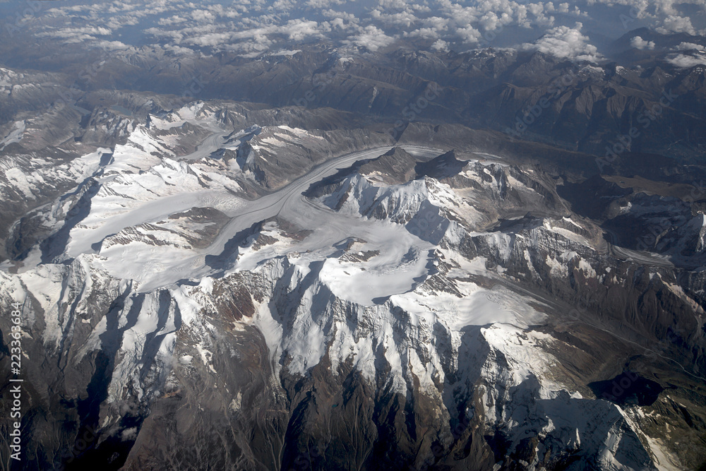 Snow-capped mountain tops from an aerial view