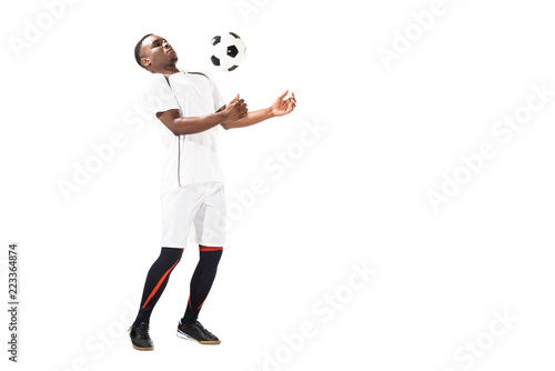 young african american soccer player hitting ball with chest isolated on white