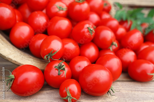 Fresh tomato crop in a wooden bowl