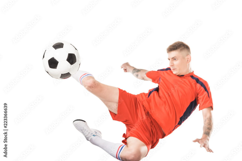 young soccer player kicking ball in jump isolated on white young soccer player kicking ball in jump isolated on white