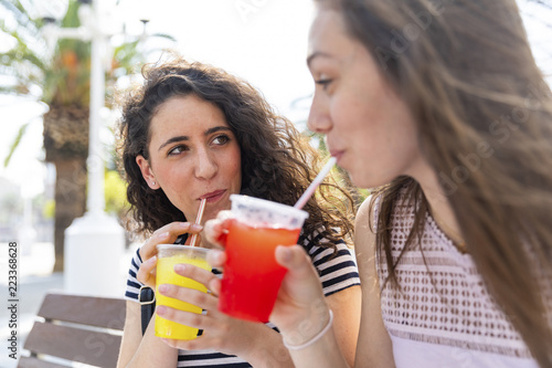 Two female friends enjoying a fresh slush photo