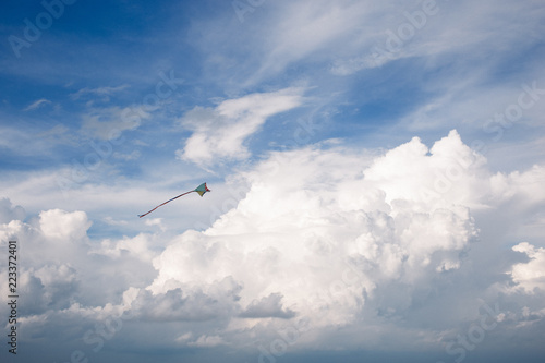 kite and Cumulus clouds and sun in the sky