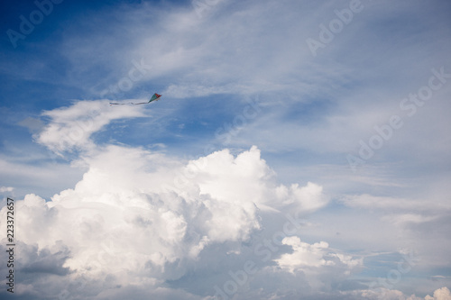 kite and Cumulus clouds and sun in the sky