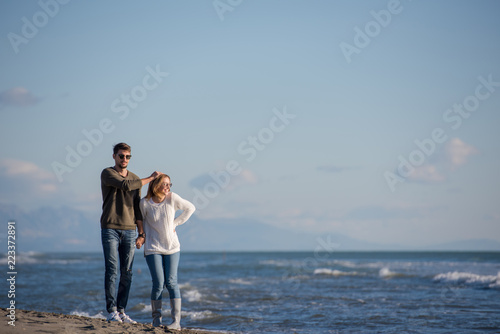 Loving young couple on a beach at autumn sunny day © .shock