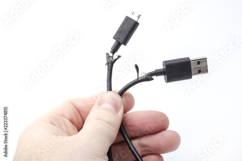 two broken usb cord in hand on a white background photo