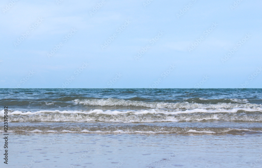 Sandy waves and beautiful sea with bright sky.
