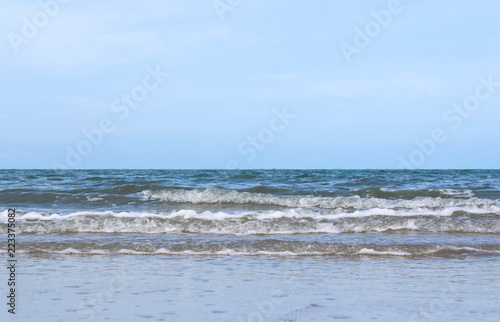 Sandy waves and beautiful sea with bright sky.