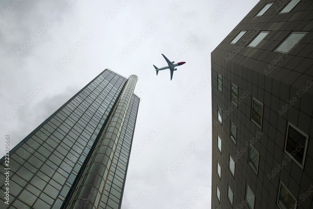 Passenger plane flies over skyscrapers Passenger plane flies over skyscrapers
