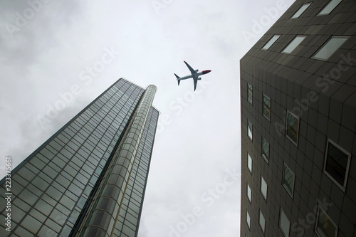 Passenger plane flies over skyscrapers
