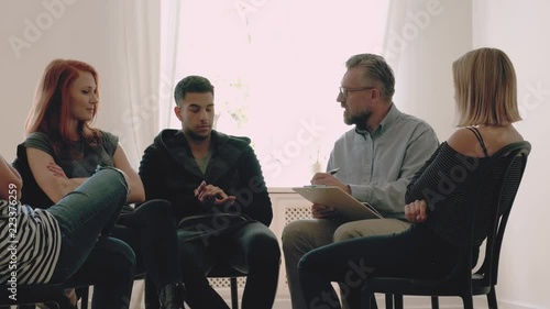 Young people listening to speaking therapist during psychotherapy in the office