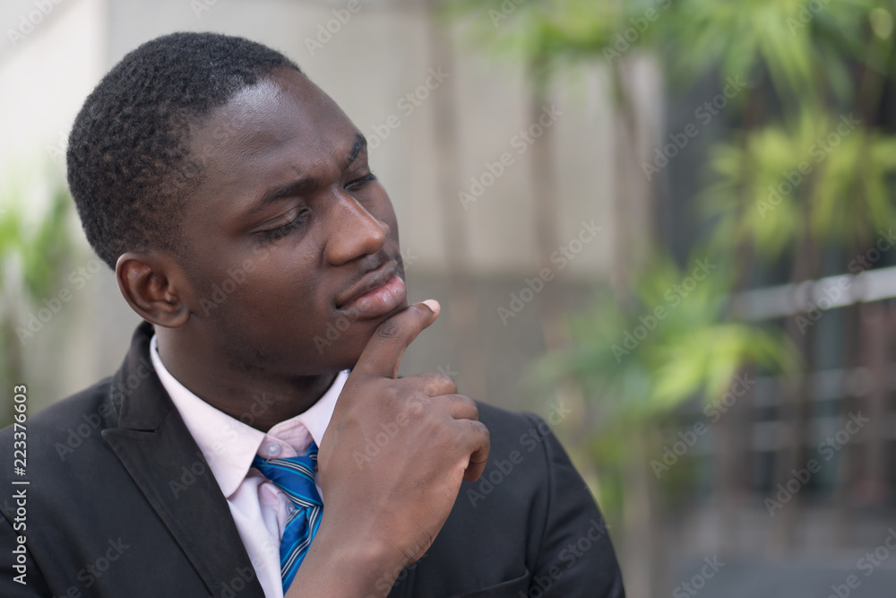 confident african or black businessman thinking; portrait of confident, thoughtful african or black business man, manager, CEO thinking, planning, finding good idea; young adult african man model confident african or black businessman thinking; portrait of confident, thoughtful african or black business man, manager, CEO thinking, planning, finding good idea; young adult african man model