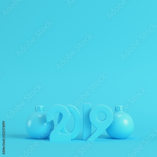Blank new year 2019 figures with christmas balls on bright blue background in pastel colors