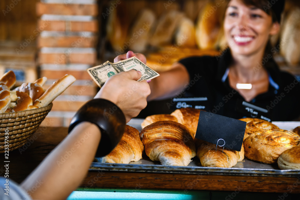 Female Shop Assistant Selling Croissant