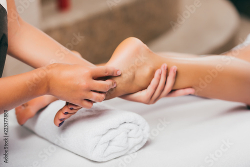 cropped view of woman relaxing and having feet massage
