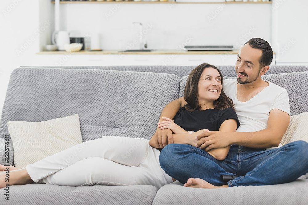 happy mature couple sitting on couch at home and relaxing togetherness.