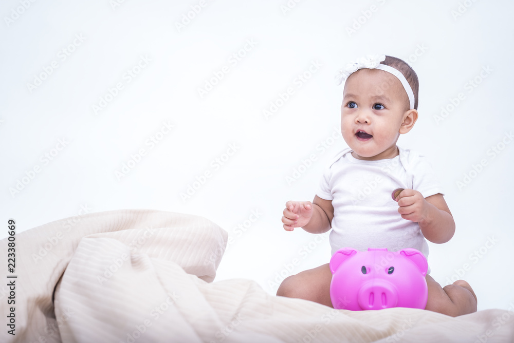 Cute baby saving money in the piggy bank - kid saving money for future concept. Cute baby saving money in the piggy bank - kid saving money for future concept.