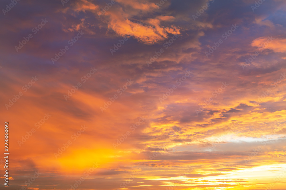 Colorful vibrant dramatic sky with purple to orange clouds. Sunset time. Beautiful nature background