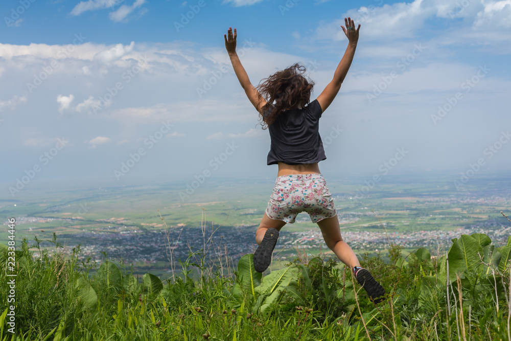 Carefree Happy Woman Enjoying Nature on grass meadow on top of mountain cliff with sunrise. Beauty Girl Outdoor. Carefree Happy Woman Enjoying Nature on grass meadow on top of mountain cliff with sunrise. Beauty Girl Outdoor.