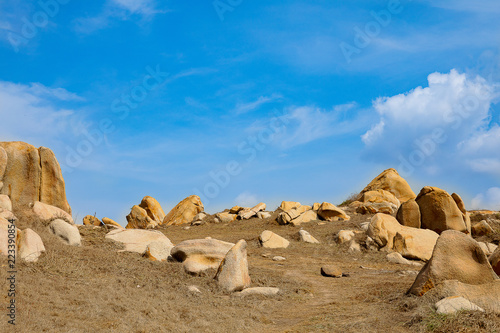 A corner at Ke Ga cape (Binh Thuan province, Vietnam) in a sunny day. It is in the dry season, so the grass is burnt. Though there are rocks everywhere, this place is very amazing for tourists.