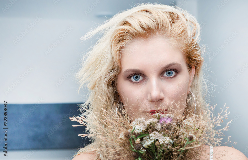 portrait of beautiful young blonde woman with bouquet of flowers portrait of beautiful young blonde woman with bouquet of flowers