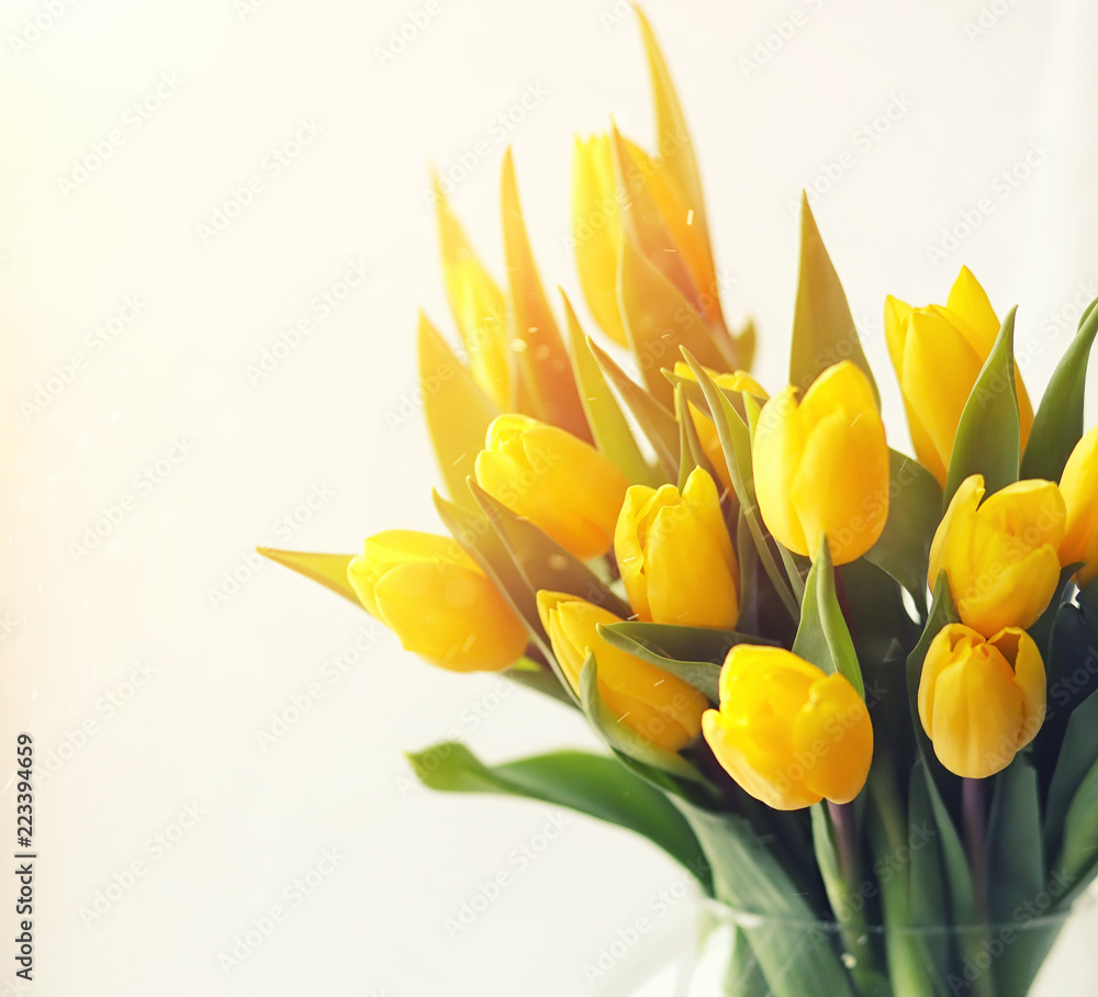 A bouquet of red tulips in a vase on the windowsill. A gift for A bouquet of red tulips in a vase on the windowsill. A gift for