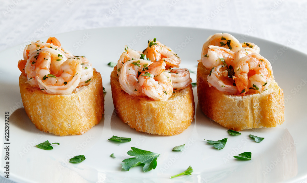 fried toast with fried in garlic oil shrimps decorated with parsley