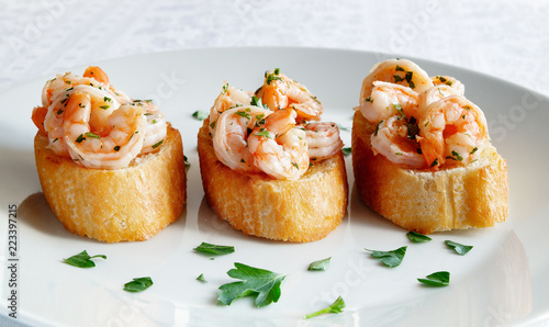 fried toast with fried in garlic oil shrimps decorated with parsley