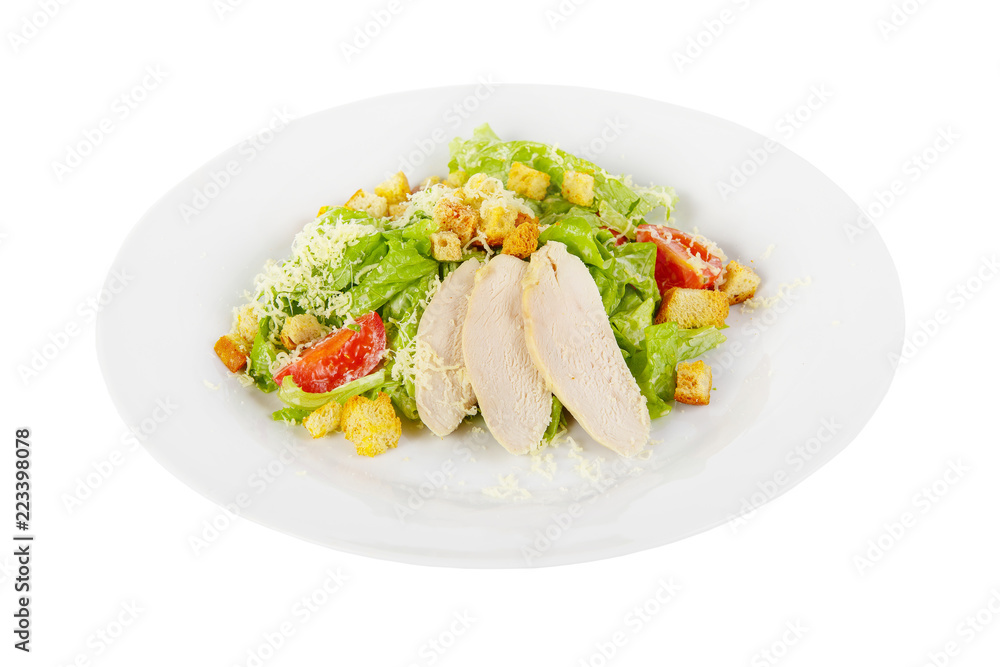 Caesar salad with slices of chicken breast, rusks, cherry tomato, lettuce, cheese on plate, white isolated background Side view. For the menu, restaurant, bar, cafe