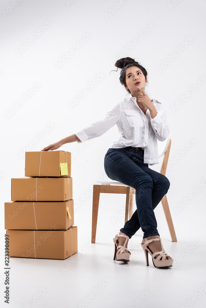 In business on line,Young beutiful entrepreneur woman,teenager business owner work and use laptop and phone call receive frome customer,take note and prepair to send product by mail. In business on line,Young beutiful entrepreneur woman,teenager business owner work and use laptop and phone call receive frome customer,take note and prepair to send product by mail.