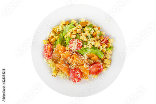 Caesar salad with fish lobes, salmon, trout, biscuits, cherry tomato, lettuce, cheese on plate, white isolated background, view from above, for the menu, restaurant bar cafe