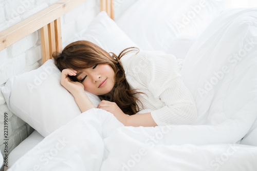 Asia woman sleep on a clean white bed. Without germs Dust mites do not cause allergies. Sleep is a process of increasing the immunity of the body. Control your heart rate to normal.