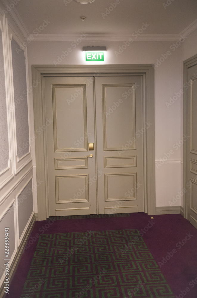 Emergency exit door in a restaurant with a neon sign Emergency exit door in a restaurant with a neon sign