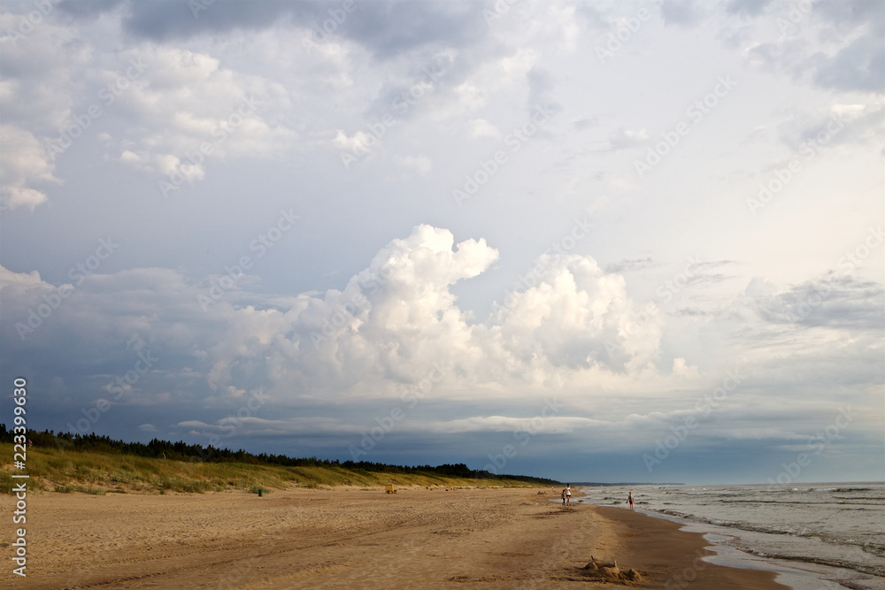 View of an wild beach with very few people View of an wild beach with very few people
