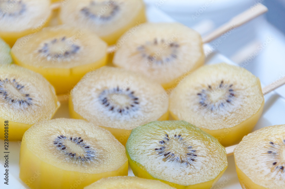 Fresh yellow sliced kiwi fruit for a healthy diet background with selective focused point Fresh yellow sliced kiwi fruit for a healthy diet background with selective focused point