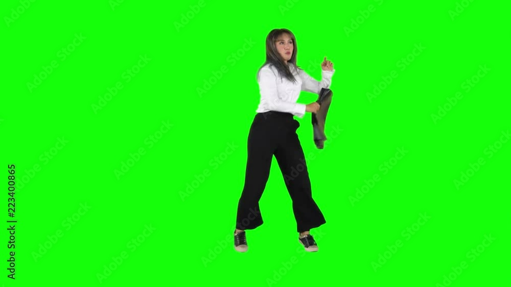 Happy businesswoman dancing and singing in the studio while holding a briefcase. Shot in 4k resolution with green screen background Happy businesswoman dancing and singing in the studio while holding a briefcase. Shot in 4k resolution with green screen background