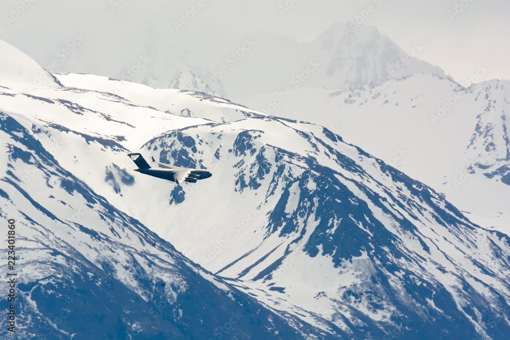 C-17 airplane in turn against snowy mountains