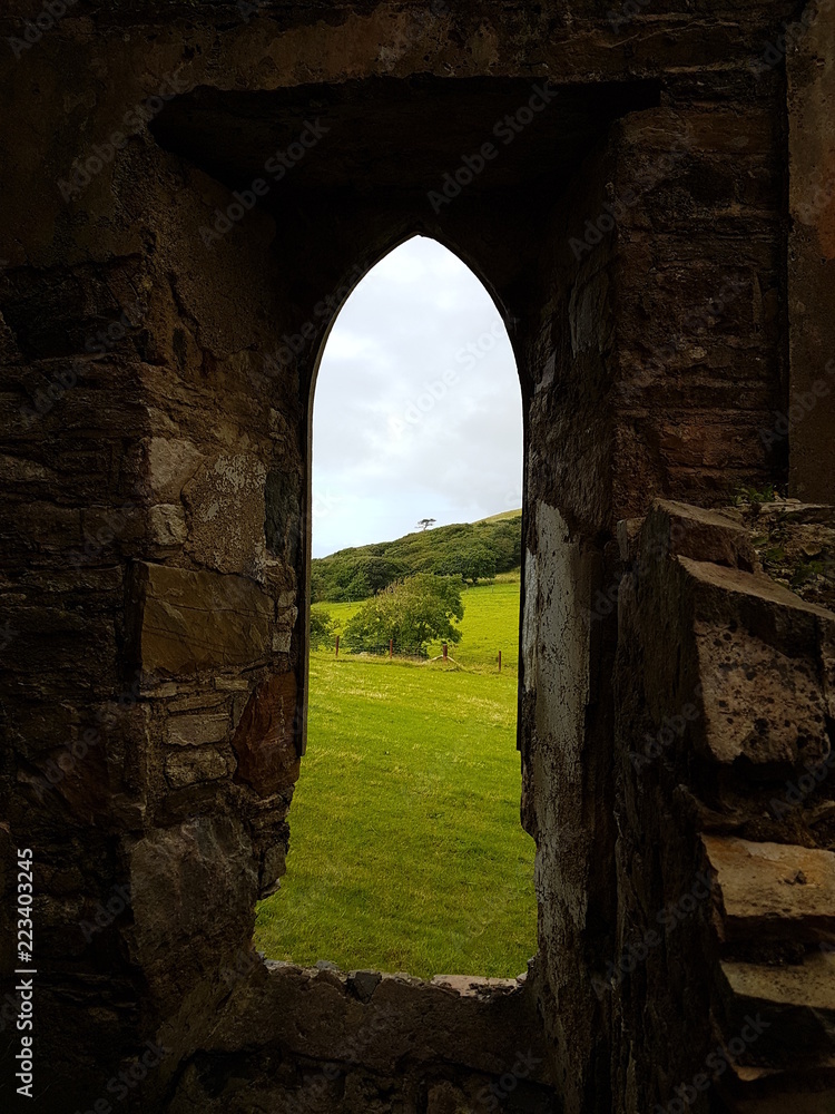 Old Arch Window in Castle Ruins with Scenic Countryside View