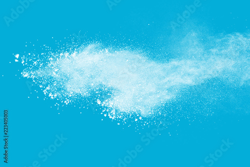 White powder explosion isolated on blue background. 
