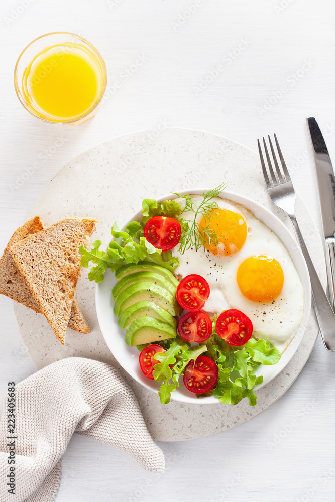 healthy breakfast flat lay. fried eggs, avocado, tomato, toasts healthy breakfast flat lay. fried eggs, avocado, tomato, toasts