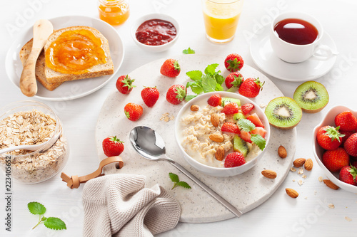 Wallpaper Mural healthy breakfast with oatmeal porridge, strawberry, nuts, toast, jam and tea Torontodigital.ca
