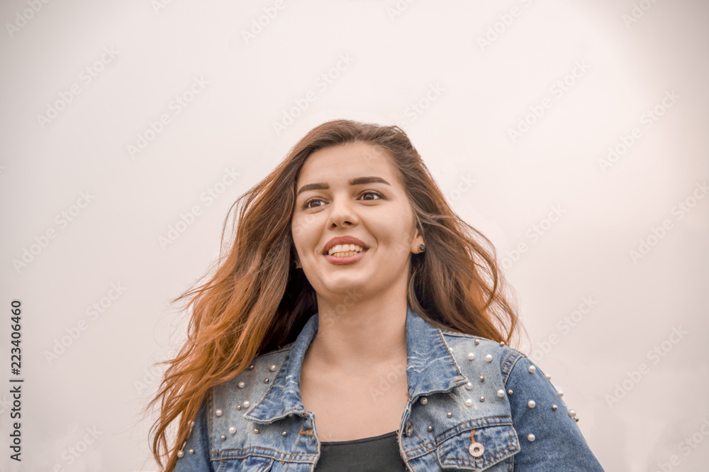 The girl on the background of white sky in cloudy weather The girl on the background of white sky in cloudy weather