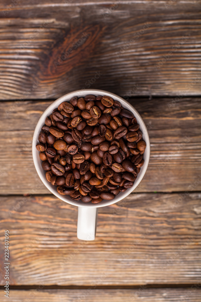 A cup filled with coffee beans A cup filled with coffee beans