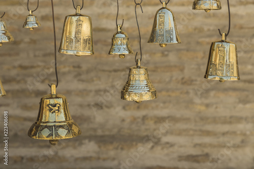 Closeup the golden bells on blurred brick background