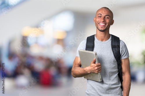 Smiling African Student man with laptop