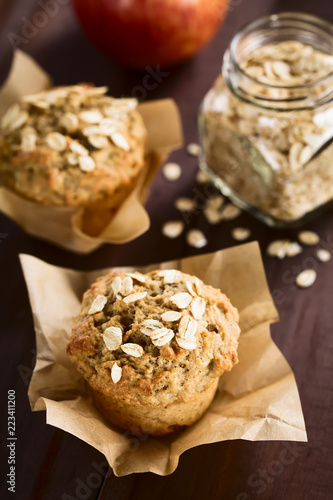 Fresh homemade apple and oatmeal muffins with oats on top (Selective Focus, Focus on the first oats on top of the first muffin)